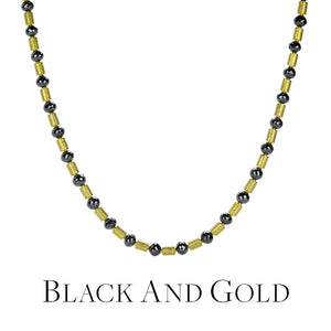 A beaded necklace with alternating faceted, round black diamond beads and 18k yellow gold tube beads, handcrafted by jewelry designer Barbara Heinrich. Link to the "black and gold" collection