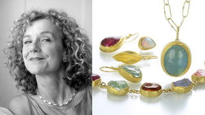 A black and white photograph of jewelry designer Petra Class with a multicolored gemstone bracelet set in 22k yellow gold bezels, an oval aquamarine cabochon pendant necklace, a pair of rough cut aquamarine drop earrings, a pair of teardrop shaped pink tourmaline earrings