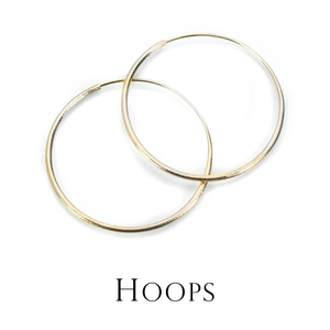 A pair of 14k yellow gold endless hoop earrings by jewelry designer Nicole Landaw. Link to the hoop earring collection