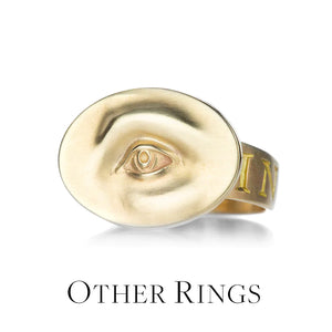 An 18k yellow gold eye ring by jewelry designer Gabriella Kiss featuring a carved eye on a wide band