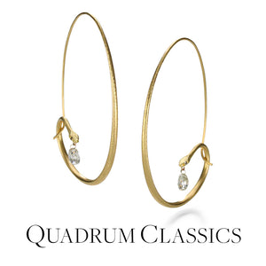 A pair of 18k yellow gold snake hoops with diamond eyes and faceted white diamond briolettes, handcrafted by jewelry designer Gabriella Kiss. Link to the "quadrum classics" collection