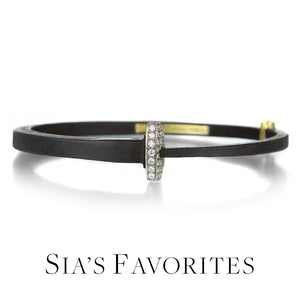 An oxidized iron nail bracelet with a pave diamond head and an 18k yellow gold hinge, handcrafted by jewelry designer Pat Flynn. Link to "Sia's Favorites" collection