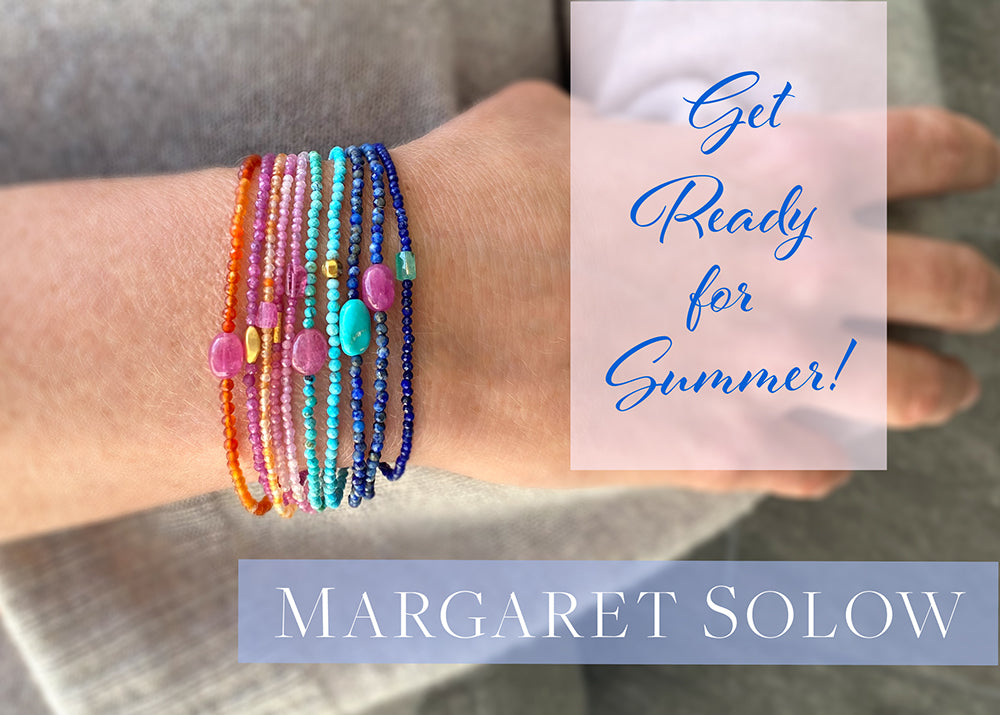 A stack of delicate gemstone beaded bracelets with carnelian, ruby, turquoise, lapis and emerald beads, handcrafted by the jewelry designer Margaret Solow