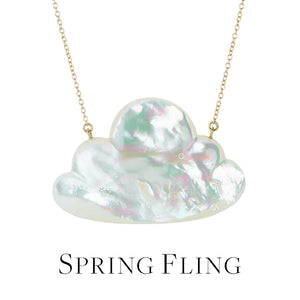 A carved, cloud shaped mother of pearl pendant with a small surface set diamond on a delicate yellow gold chain by jewelry designer Annette Ferdinandsen. Link to the "spring fling" collection