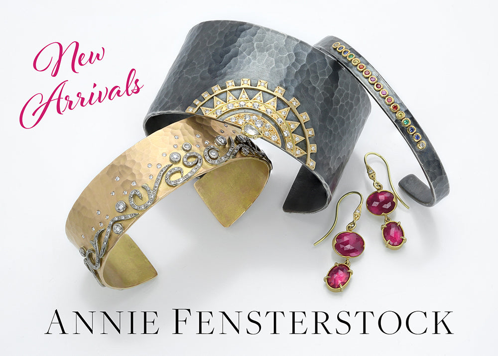 annie fensterstock oxidized silver cuff with an 18k yellow gold and diamond cuff, a pair of double ruby drop earrings in 18k yellow gold settings and a thin, oxidized silver cuff with rainbow colored sapphires