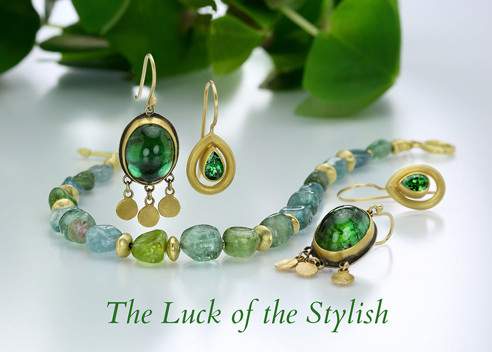 A pair of oval, green tourmaline drop earrings by jewelry designer Ananda Khalsa, a pear shaped 18k yellow gold earring with a bright green tourmaline center by jewelry designer mallary marks
