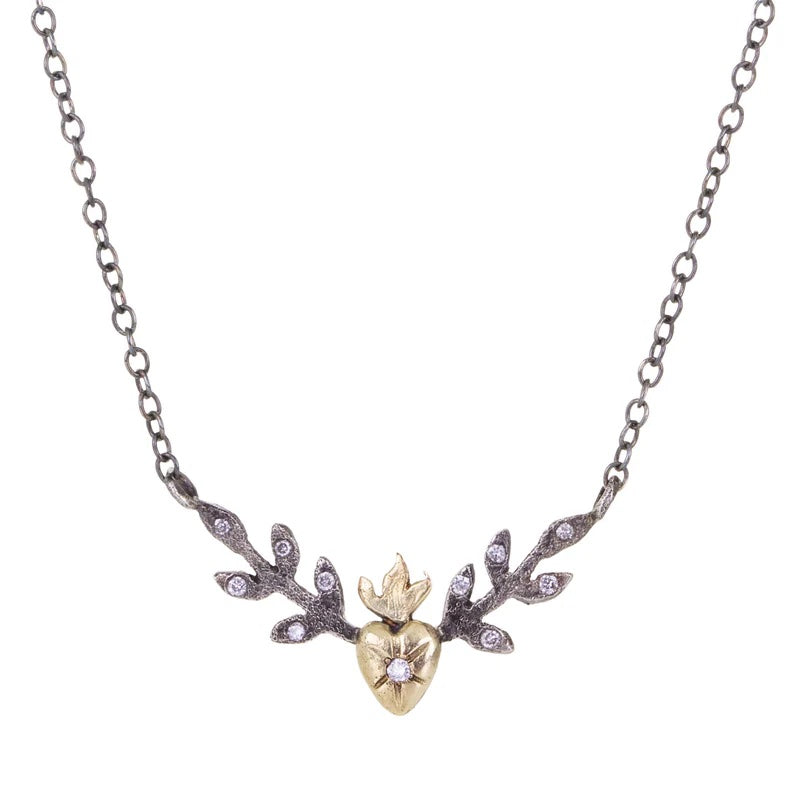 Necklace with heart and branch design on a white background