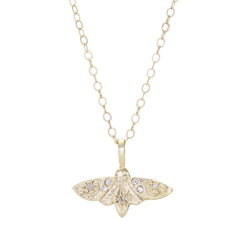 Gold butterfly pendant necklace on a white background