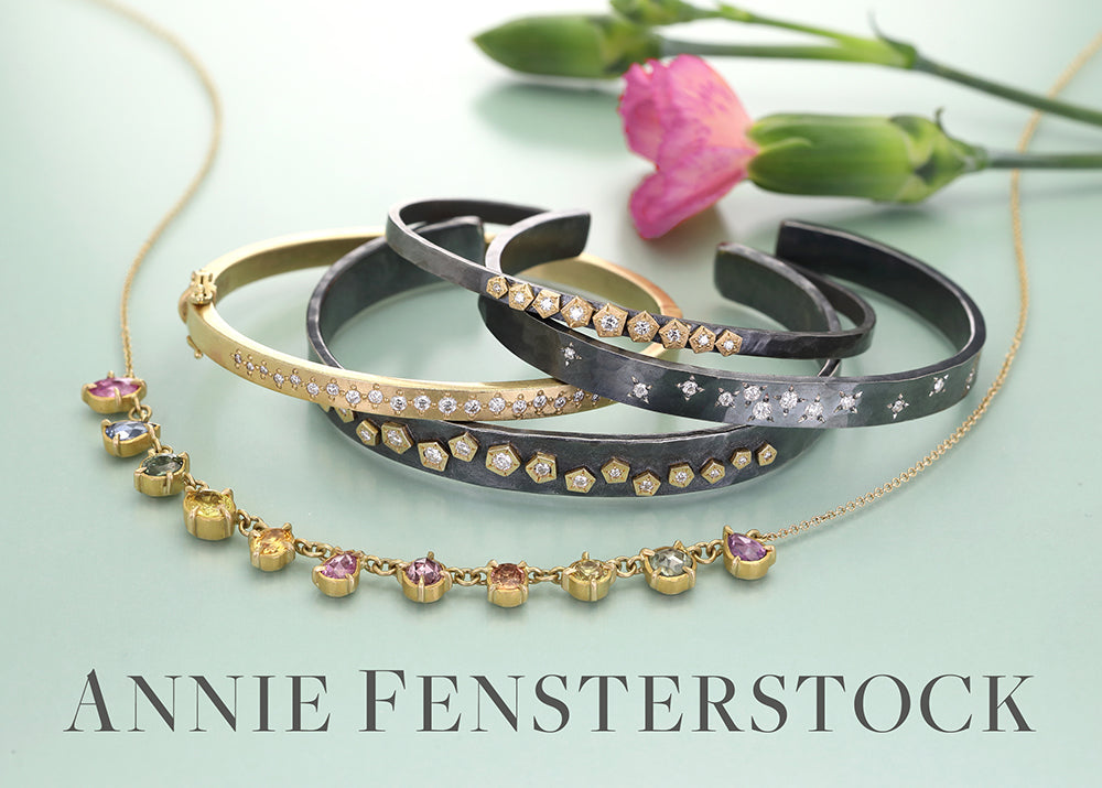 Jewelry set with bracelets and a necklace on a light background, featuring the brand 'Annie Fensterstock'.