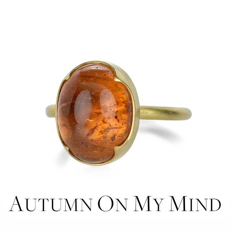 Ring with amber stone and gold band on a white background, text 'Autumn on My Mind' below.
