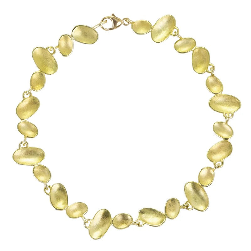 Gold necklace with pebble-like links on a white background