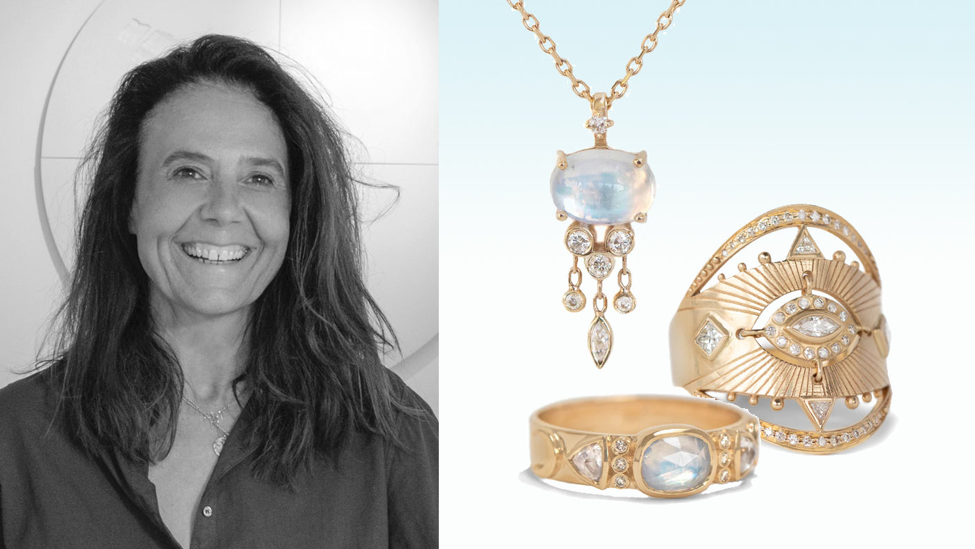 Woman with jewelry on display, including a necklace and two rings.