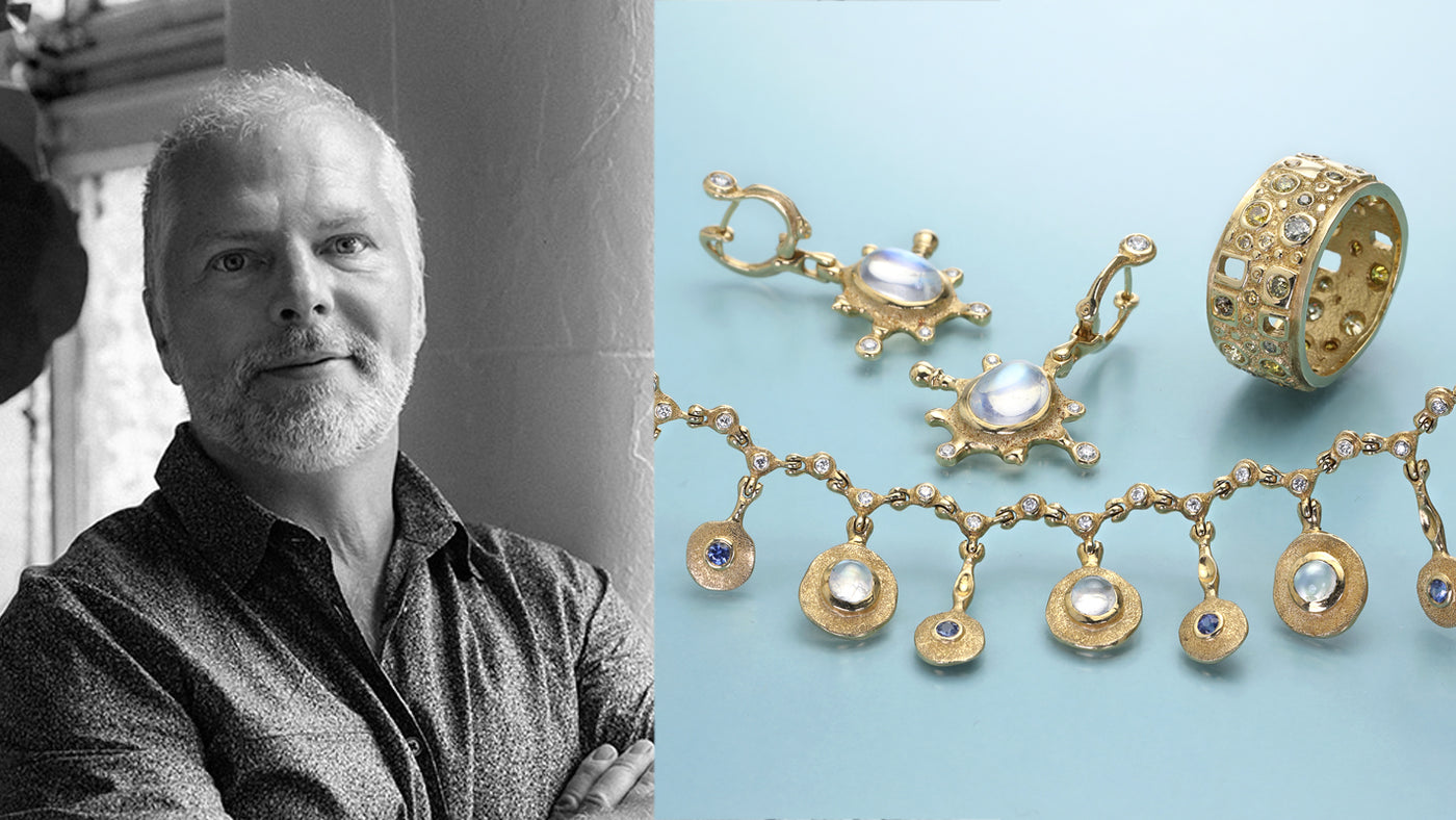 Person next to gold jewelry set on a light blue background