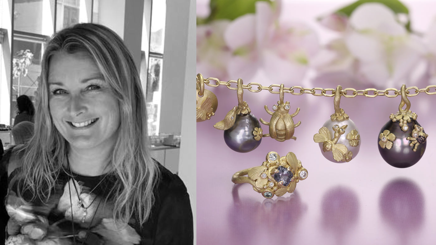 Woman holding a baby and gold jewelry with hanging charms on a purple background