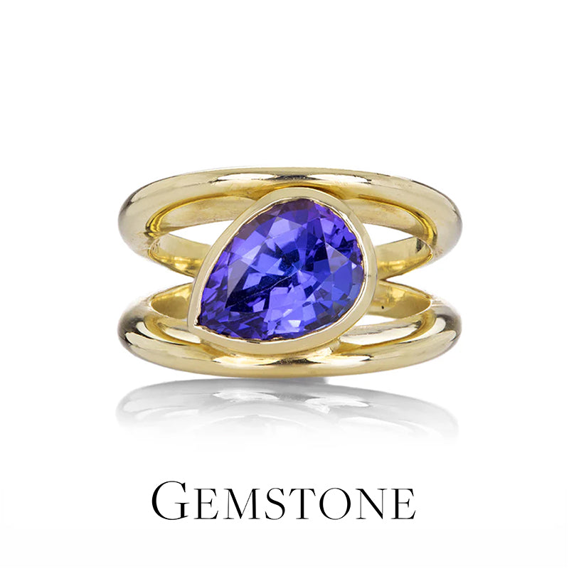Gold ring with a purple gemstone on a white background