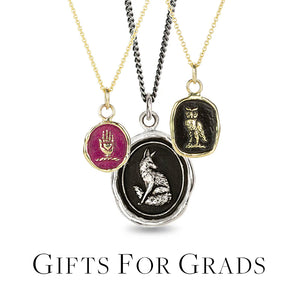 An 18k yellow gold chain with an oval pendant with hot pink enamel with a hand, a silver chain necklace with an oval fox pendant and another 18k yellow gold necklace with a rectangular owl pendant. Necklaces handcrafted by Pyrrha. 