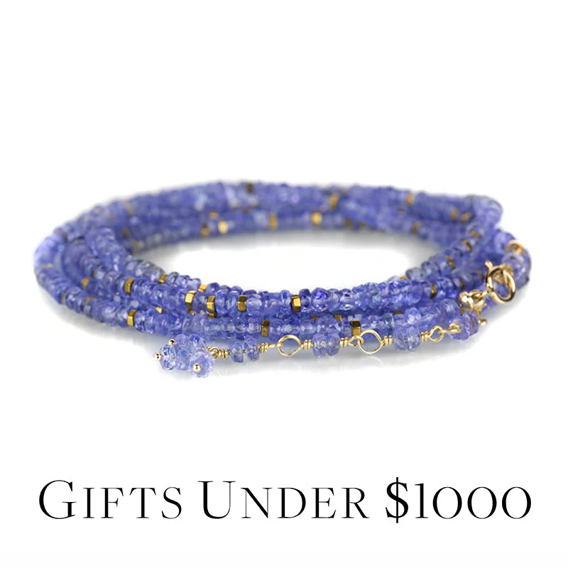 Blue beaded bracelet with gold accents on a white background, labeled 'Gifts Under $1000'.