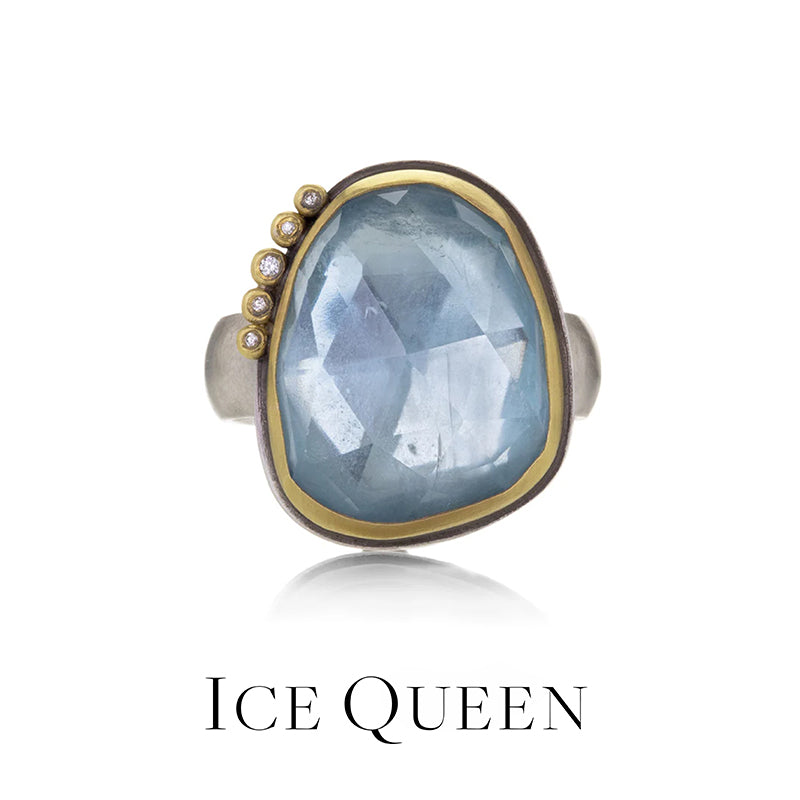 Ring with a large blue stone and gold accents on a white background, labeled 'Ice Queen'.