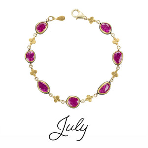 Gold bracelet with pink gemstones on a white background, labeled 'July'.