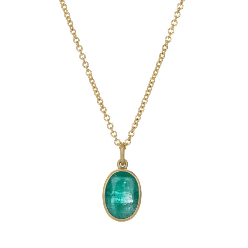 Gold necklace with a green pendant on a white background