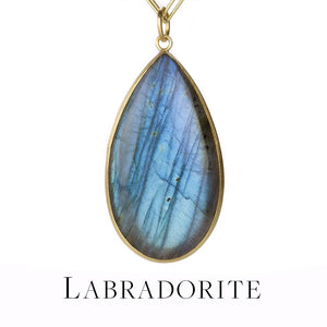 A pear shaped labradorite pendant set in an 18k yellow gold bezel, handcrafted by jewelry designer Maria Beaulieu. Link to the labradorite collection