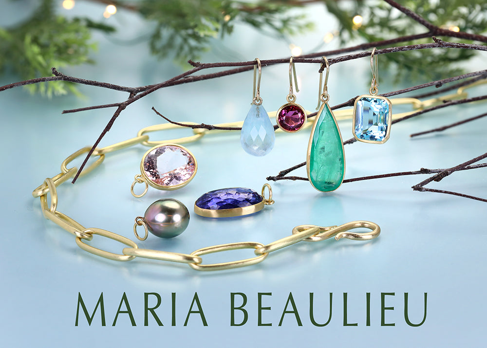 Jewelry set including earrings and a bracelet on a branch with 'Maria Beaulieu' branding.