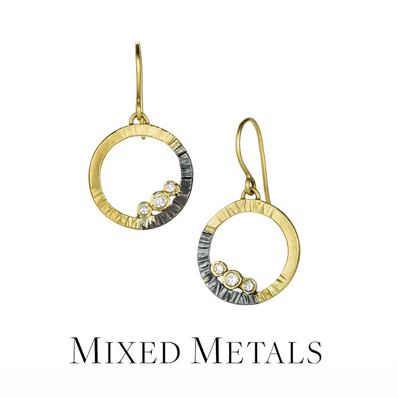 Pair of gold and silver earrings with 'Mixed Metals' text on a white background