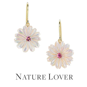A pair of soft pink, carved mother of pearl flower drop earrings with prong set, bright pink tourmaline center stones, hanging from yellow gold earwires, handcrafted by jewelry designer Nicole Landaw. Link to the "nature lover" collection