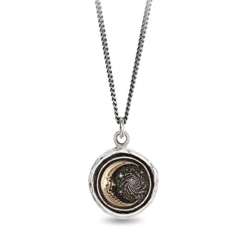 Necklace with a circular pendant featuring a celestial design on a white background
