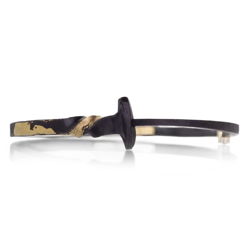 Black and gold hair clip on a white background