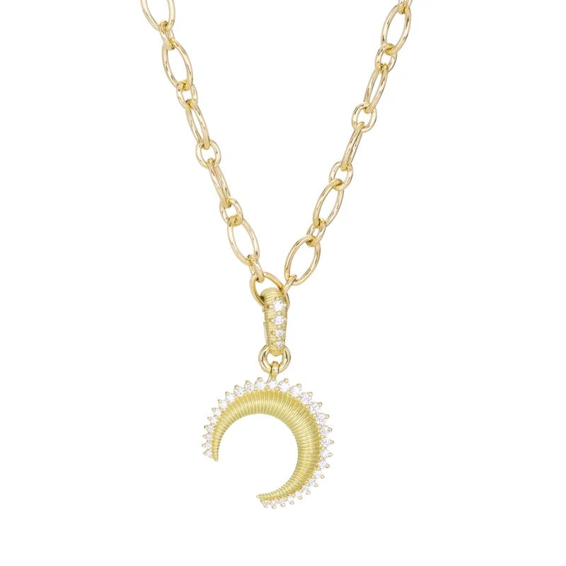 A gold chain necklace featuring a crescent moon pendant adorned with small clear stones, shown against a plain white background.