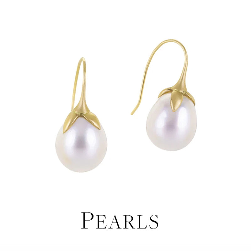 Pearl earrings with gold hooks on a white background