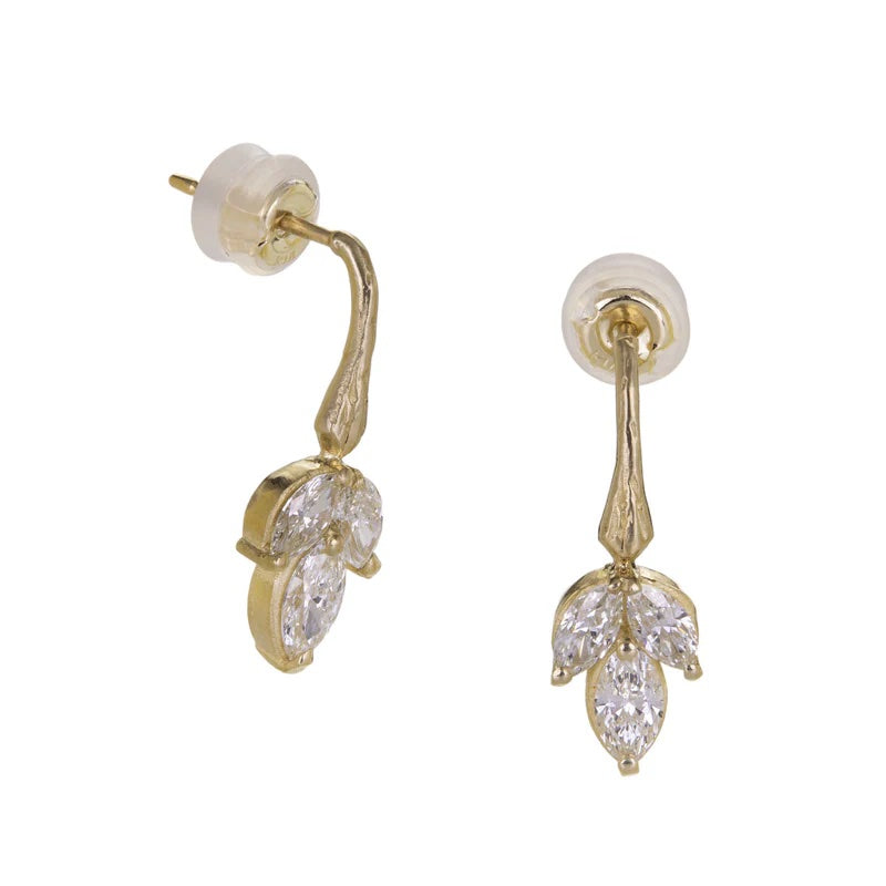 Gold earrings with clear gemstones on a white background