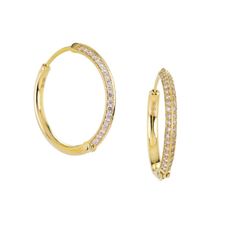 Gold hoop earrings with embedded diamonds on a white background