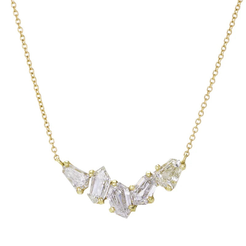 Gold necklace with clear gemstones on a white background