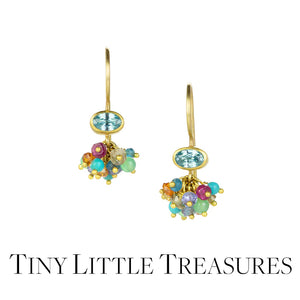 A pair of 18k yellow gold earrings with bezel set, faceted blue zircons paired with a cluster of multicolored gemstones. Handcrafted by jewelry designer Mallary Marks.