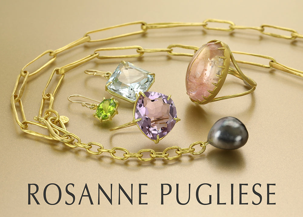 A handcrafted 22k yellow gold open link chain with a gray Tahitian pearl pendant, three gemstone earrings featuring faceted amethyst, peridot and aquamarine drops and a prong set pink morganite cabochon ring, all handcrafted by jewelry designer Rosanne Pugliese.